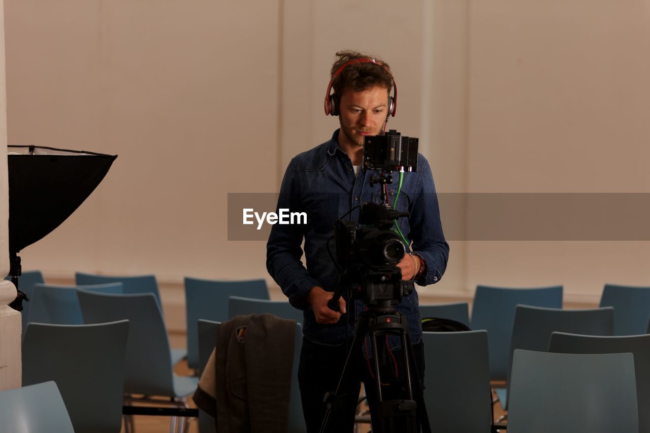 Photographer operating digital camera in studio