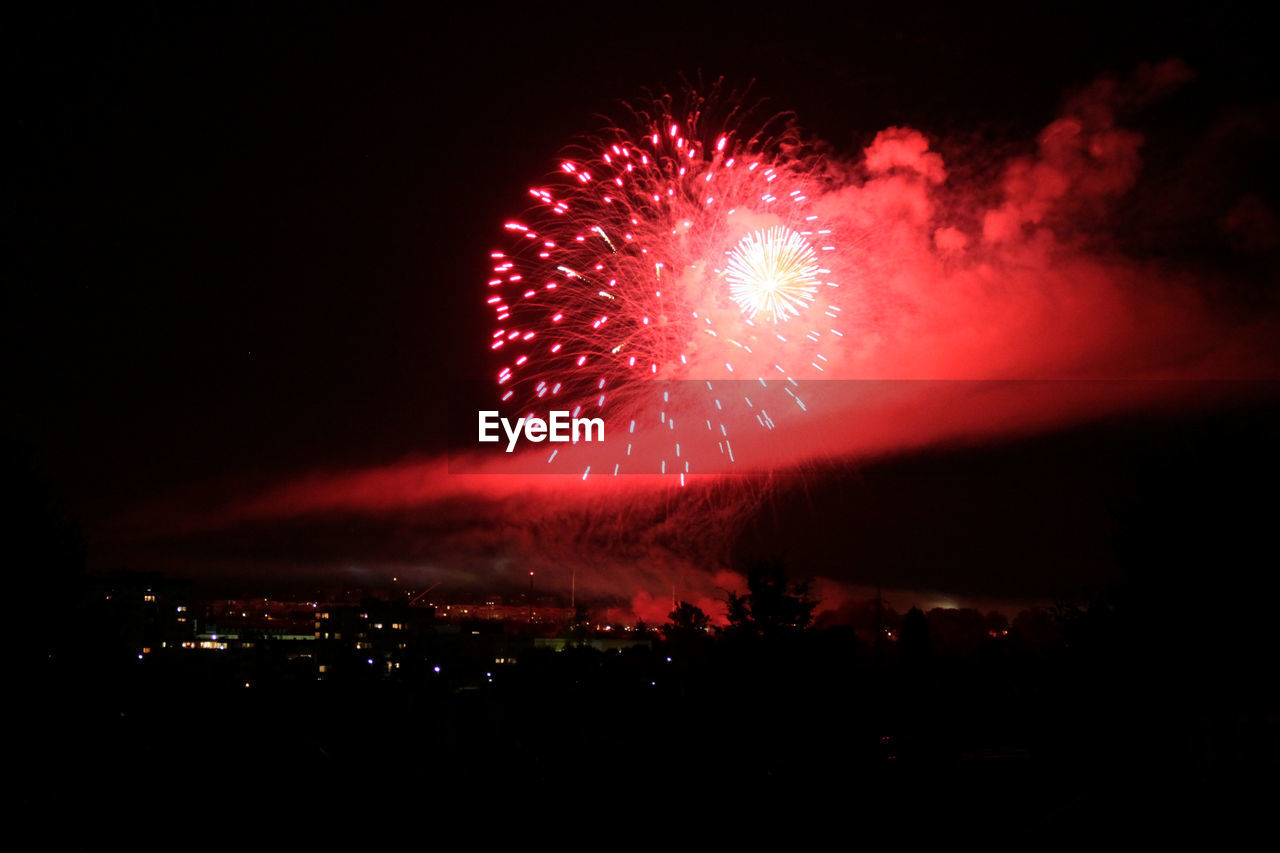 Colorful firework display over town