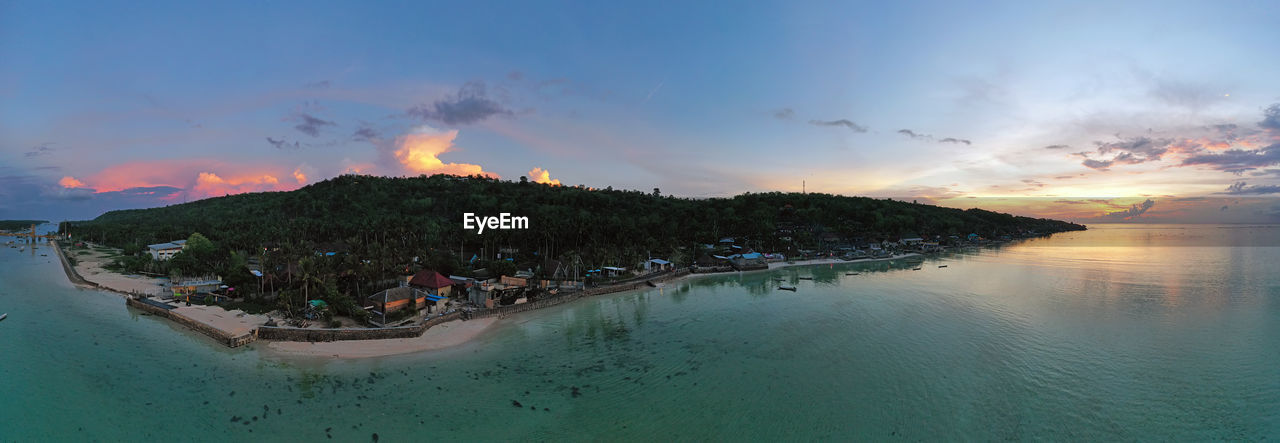 PANORAMIC SHOT OF SEA AGAINST SKY DURING SUNSET