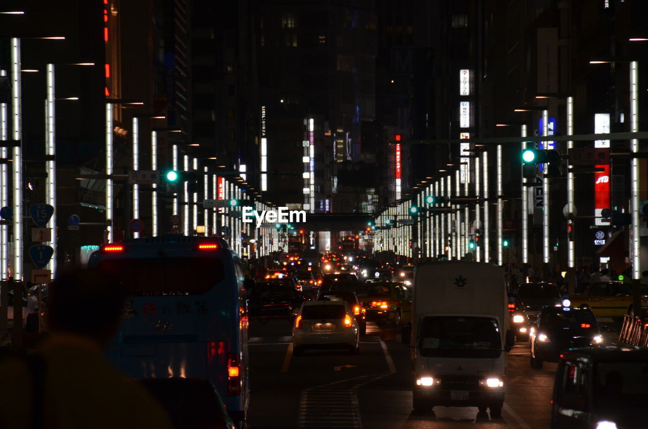 Vehicles on road in city at night