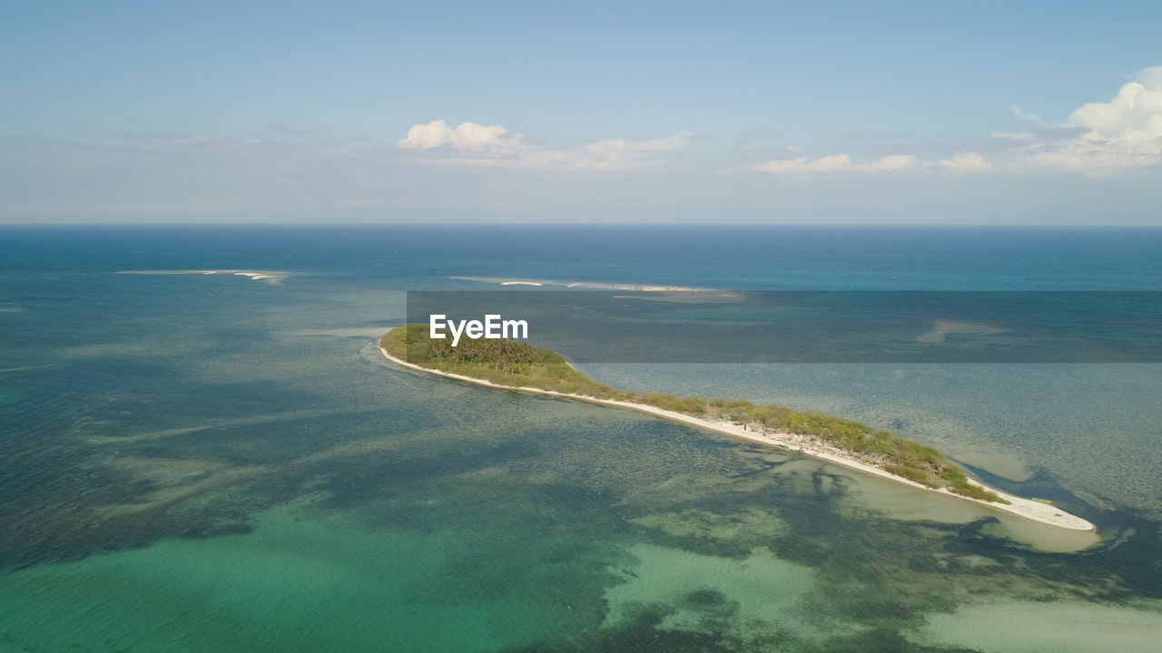 Tropical island with white sandy beach, palm trees. aerial view of tanduyong island 