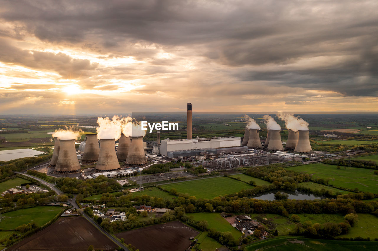 Aerial landscape view of drax power station with smoking chimneys pumping co2 into air at  sunset