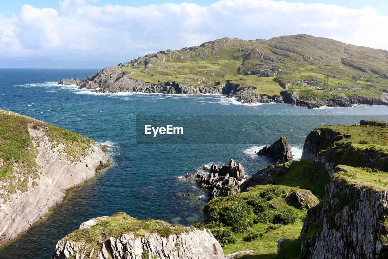 Scenic view of mountains by sea