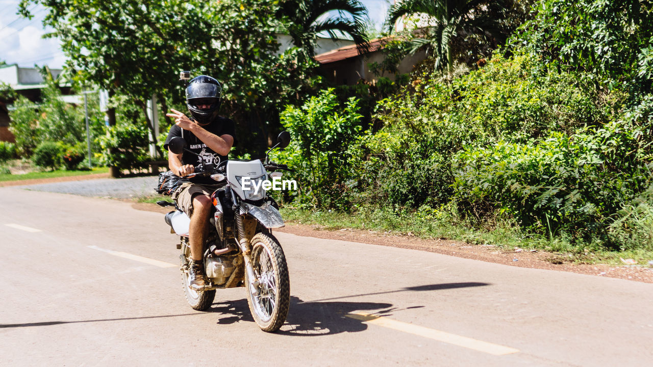 Man riding motorbike on road