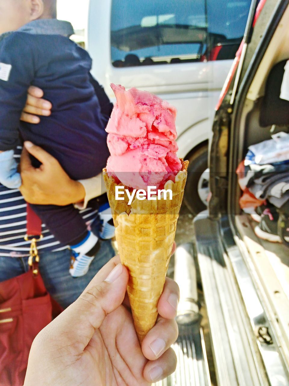 MIDSECTION OF MAN HOLDING ICE CREAM CONE