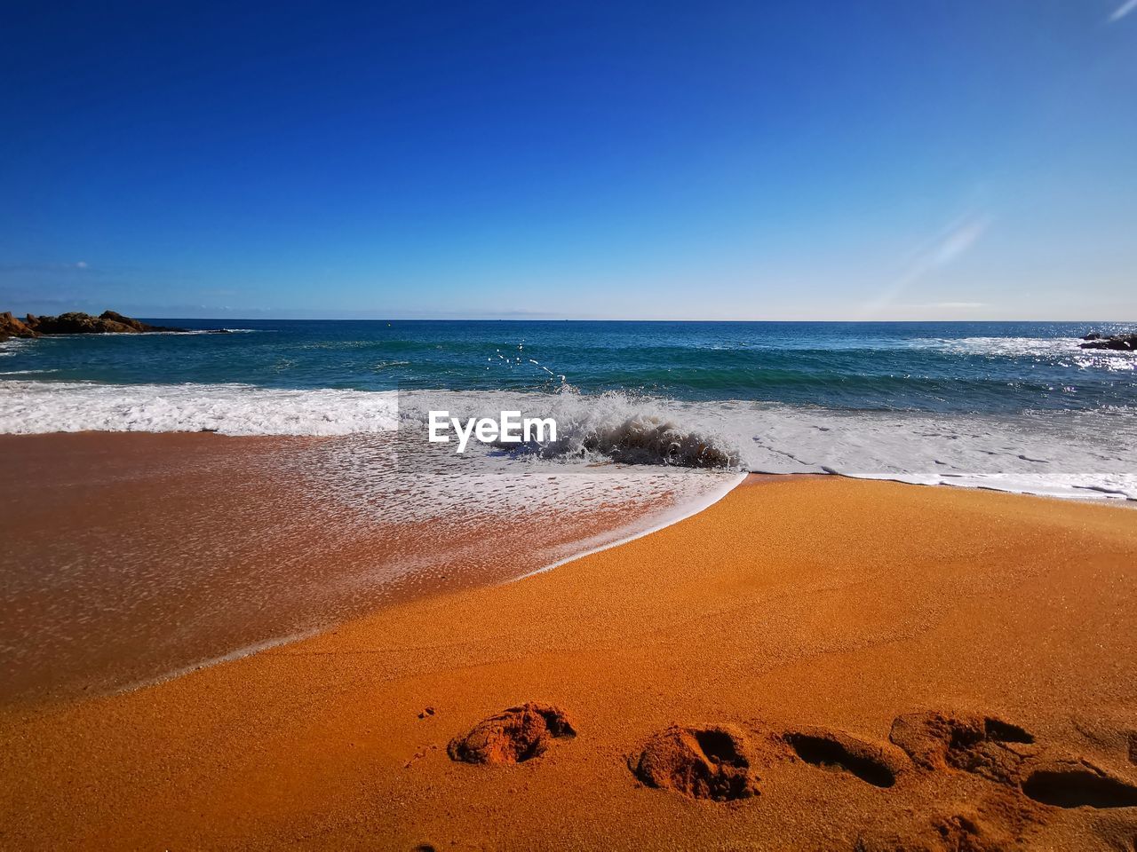 Scenic view of beach against clear sky