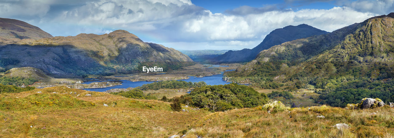 PANORAMIC SHOT OF LAND AND MOUNTAINS AGAINST SKY