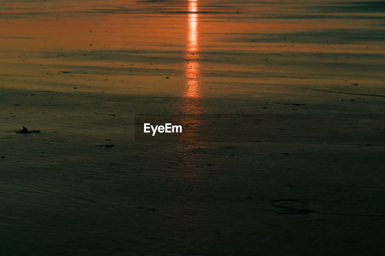 Reflections of the setting sun in the sand