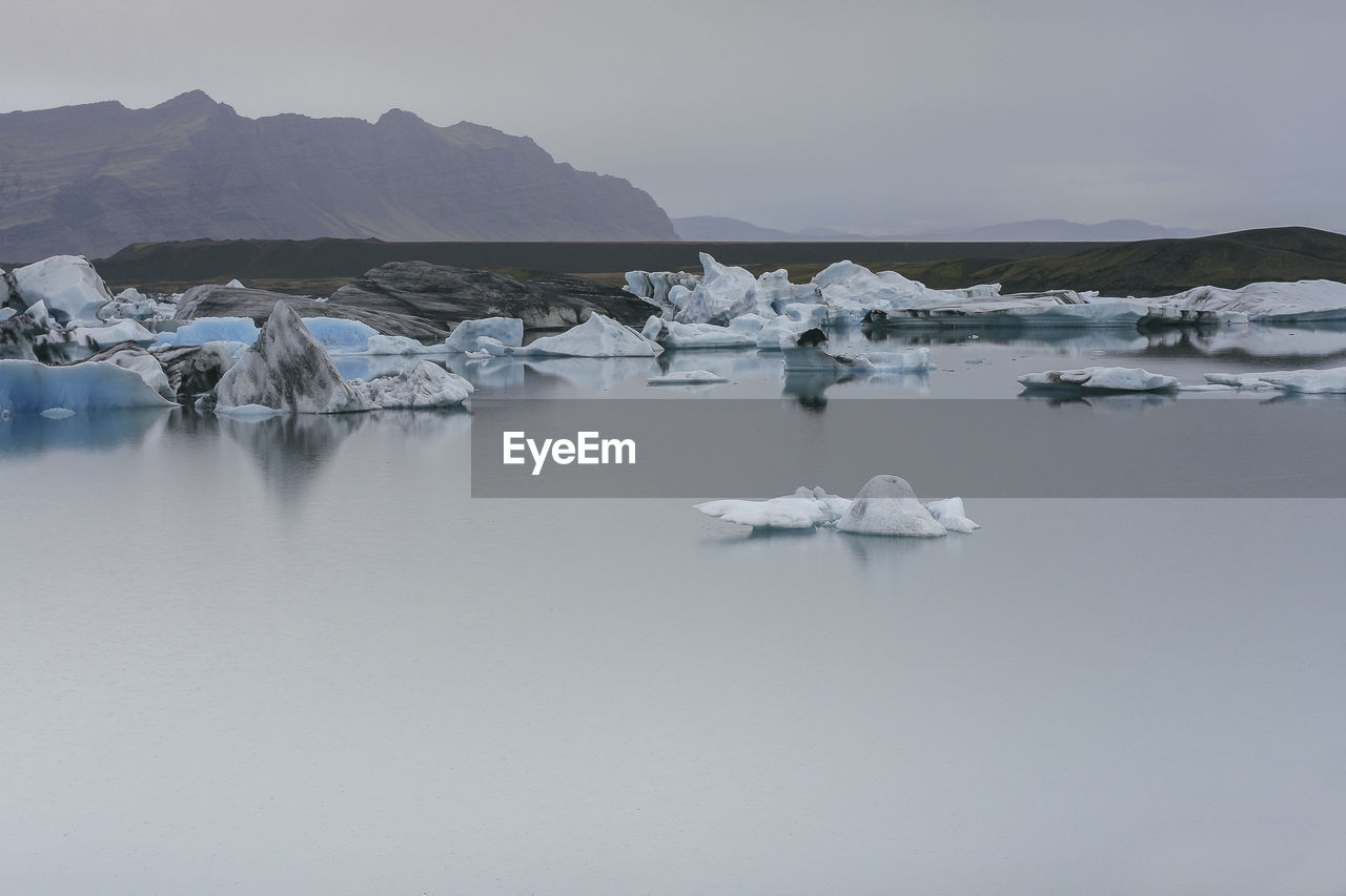 Scenic view of trip jökulsárlón lake against sky during winter