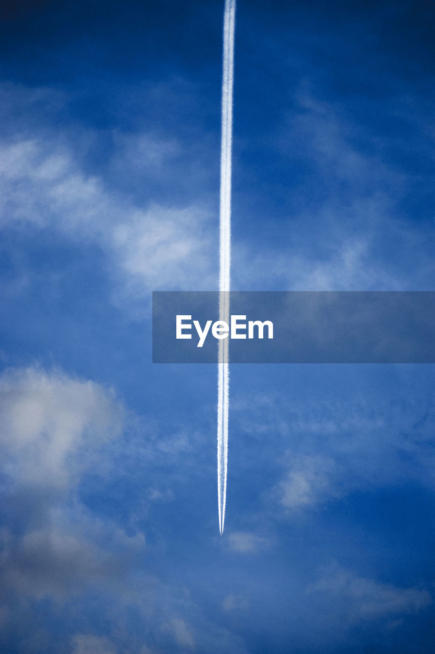 LOW ANGLE VIEW OF VAPOR TRAILS IN SKY