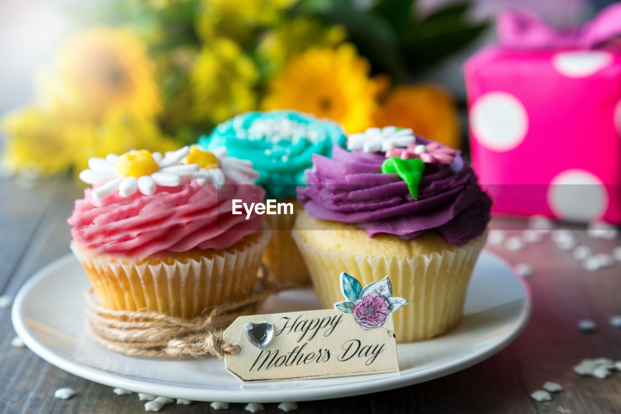 Close-up of cupcakes with label on table