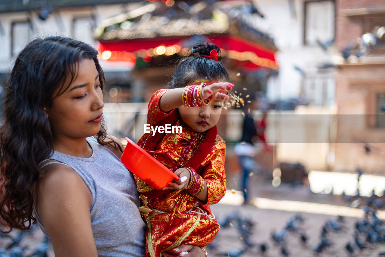 GIRL HOLDING WOMEN IN CITY