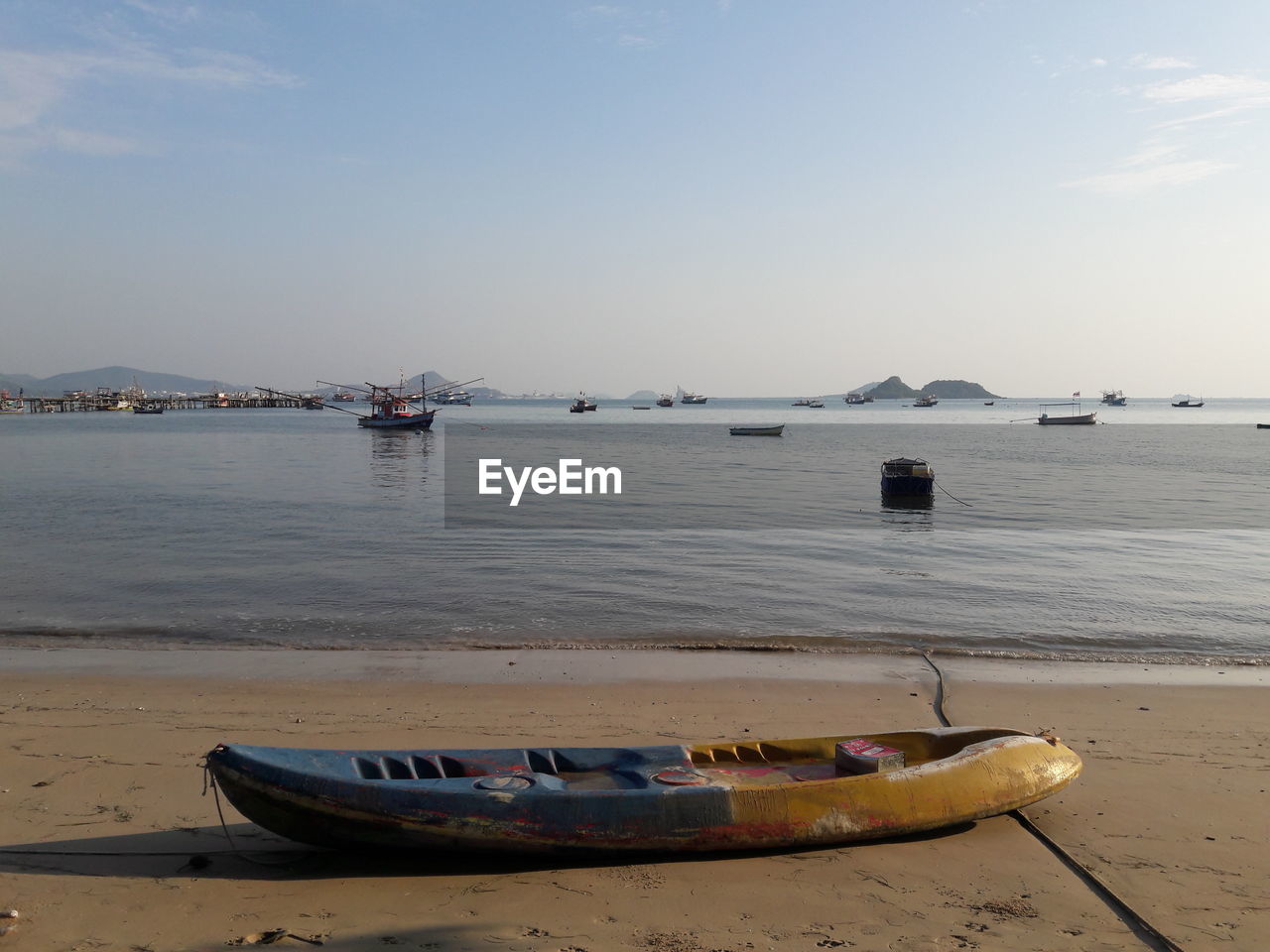BOATS MOORED ON SEA AGAINST SKY
