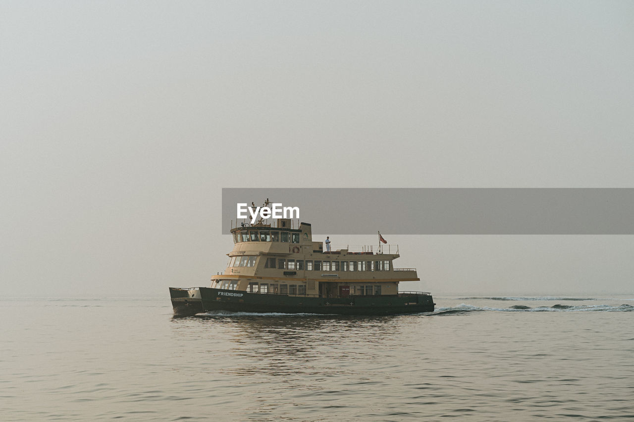 SHIP SAILING IN SEA AGAINST CLEAR SKY