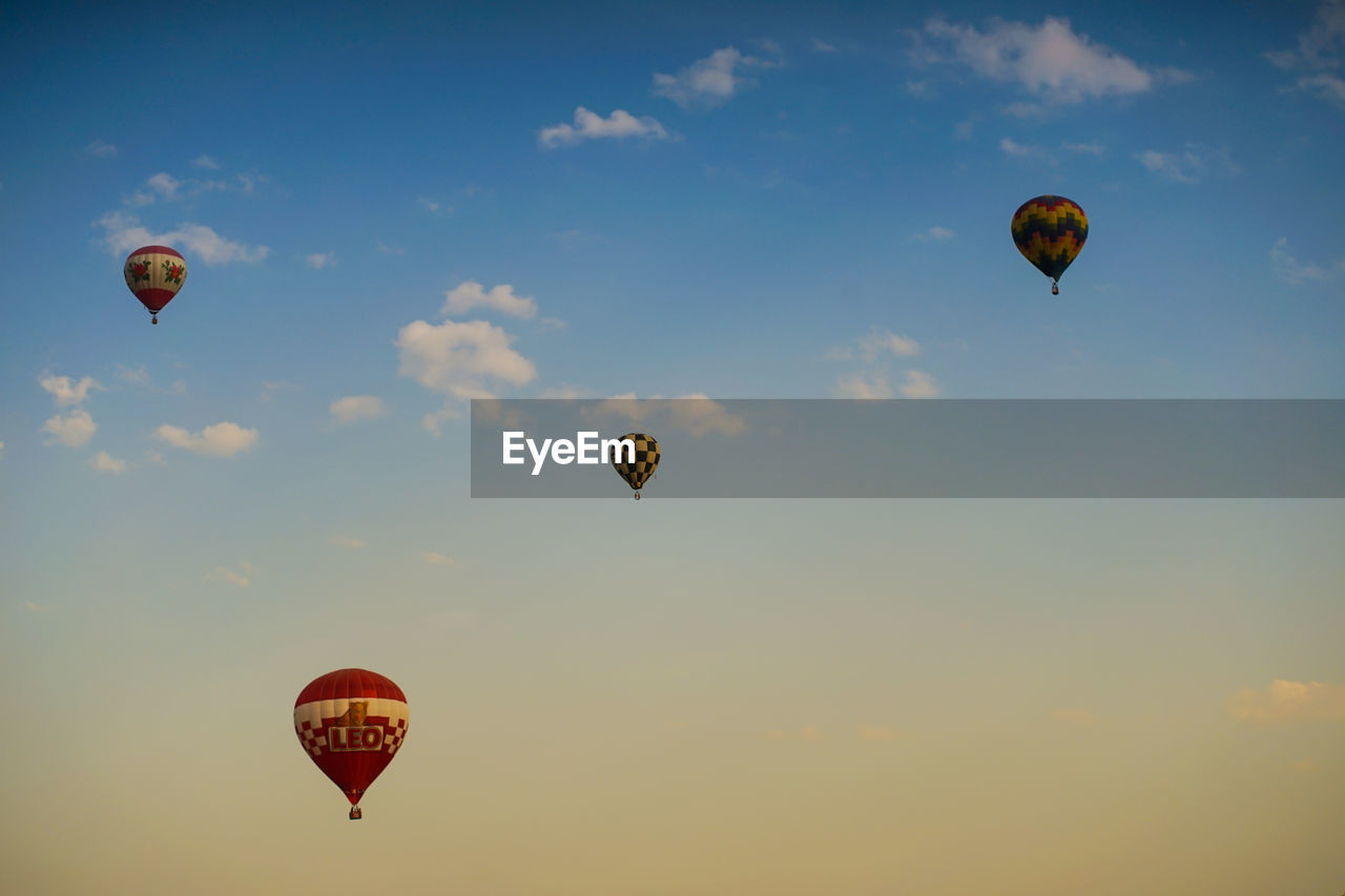 HOT AIR BALLOONS FLYING AGAINST SKY