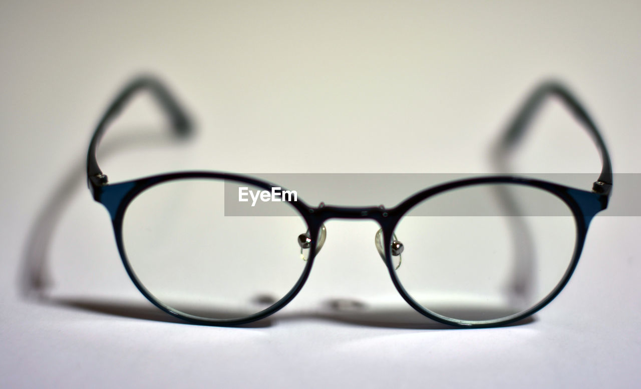 CLOSE-UP OF EYEGLASSES ON TABLE