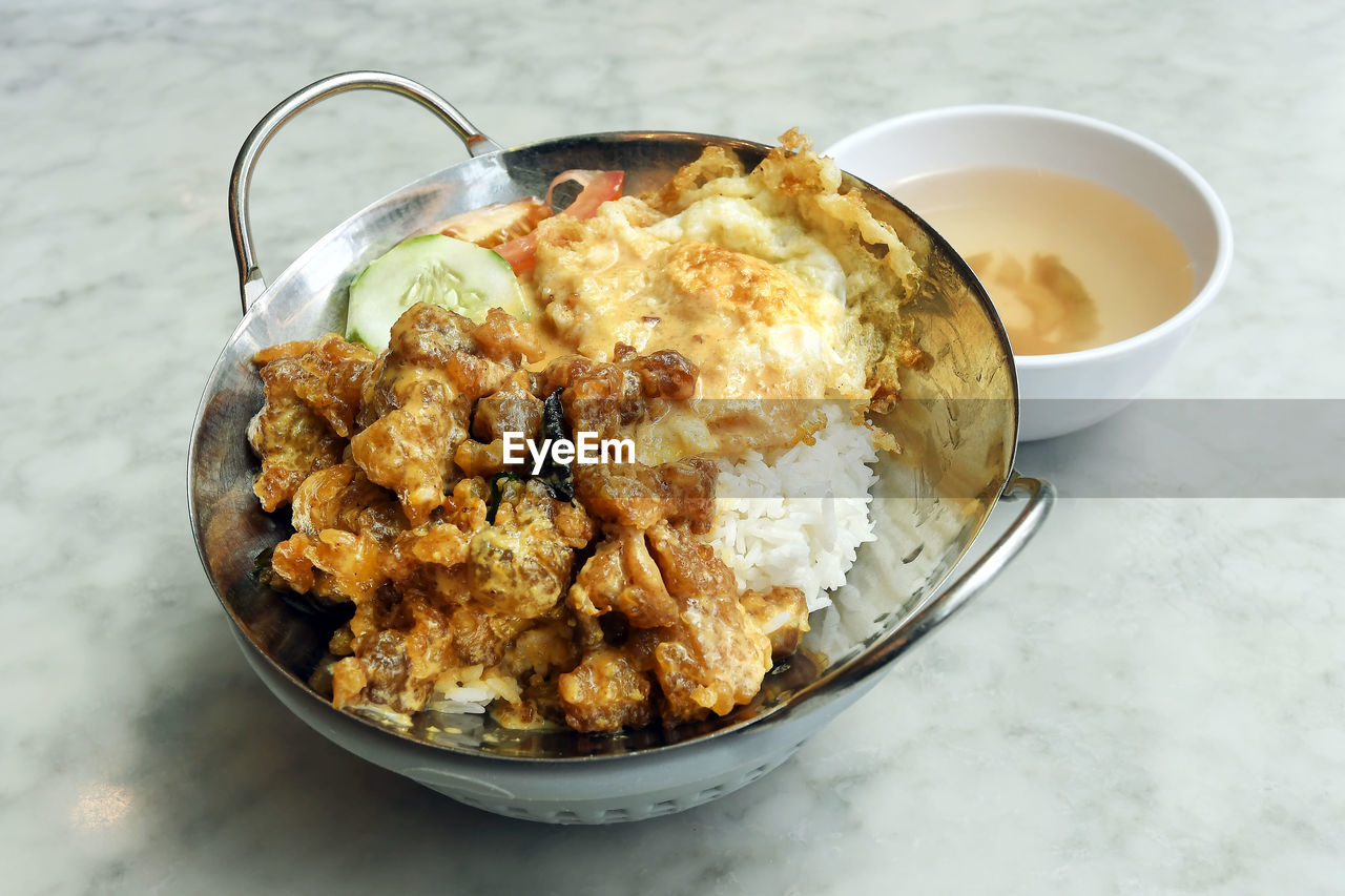 Close-up of egg with chicken and rice