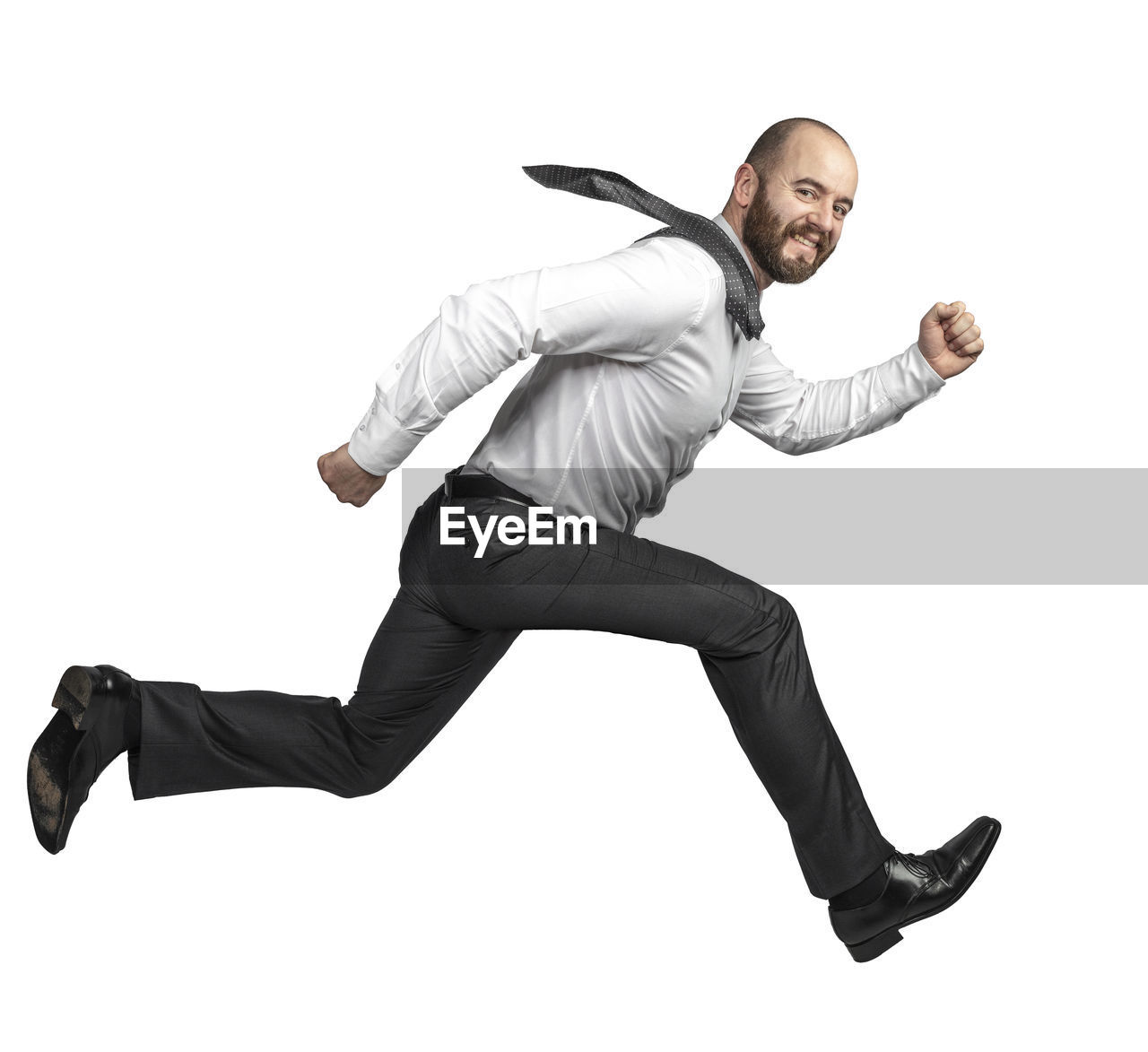 FULL LENGTH PORTRAIT OF MAN AGAINST GRAY BACKGROUND