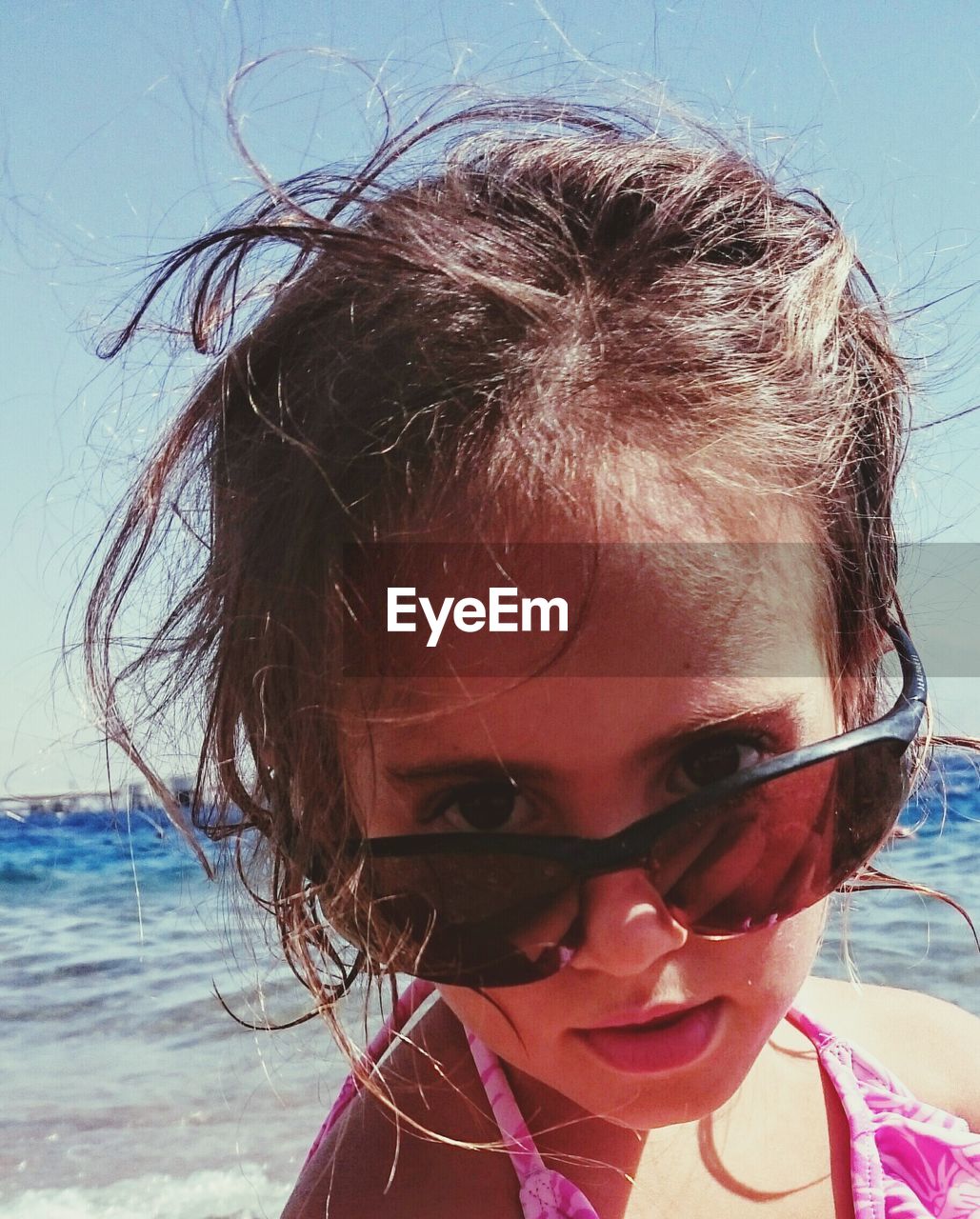 Portrait of girl with sunglasses at beach
