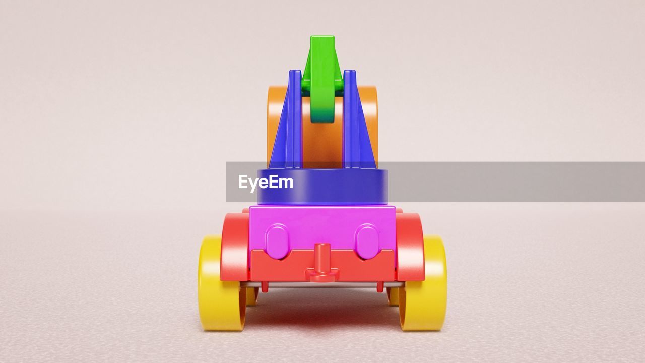 CLOSE-UP OF MULTI COLORED TOY ON TABLE