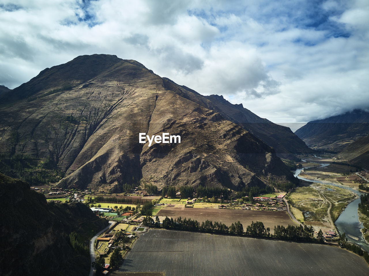 Scenic view of mountains against cloudy sky