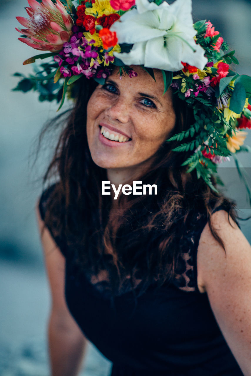 Portrait of woman wearing multi colored flowers