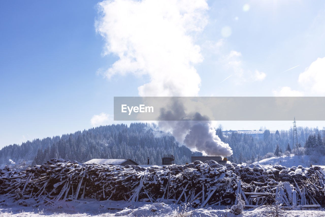 Air pollution smoke from factory chimney at rural nature in winter