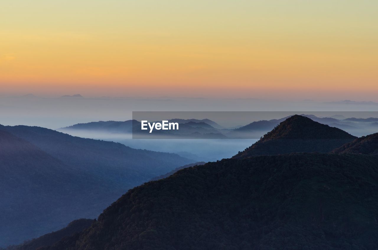 Scenic view of mountains against sky during sunset