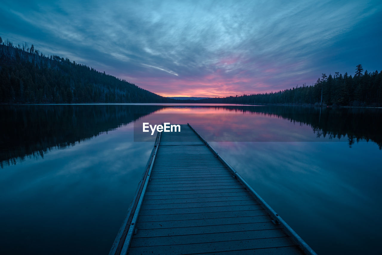 Scenic view of lake against sky at sunset