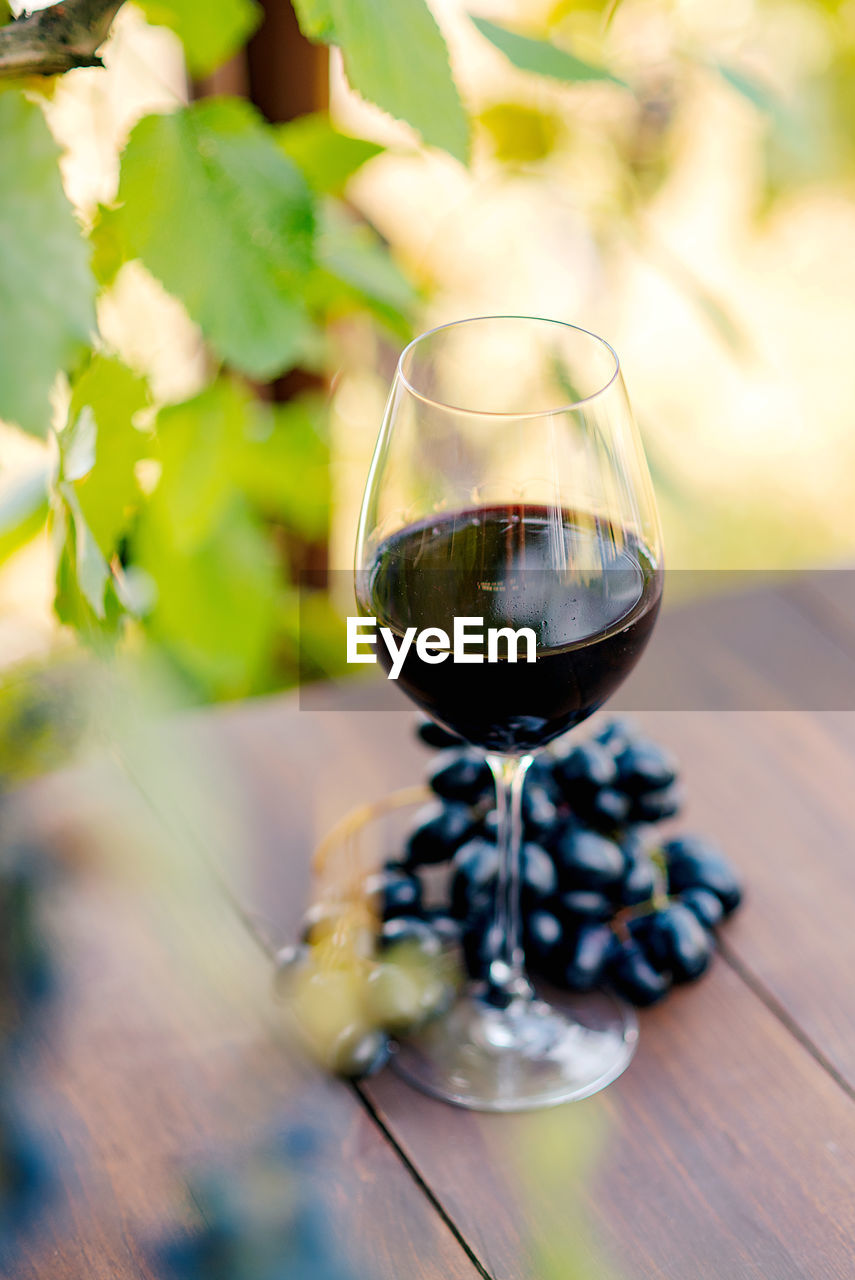 close-up of wineglass on wooden table