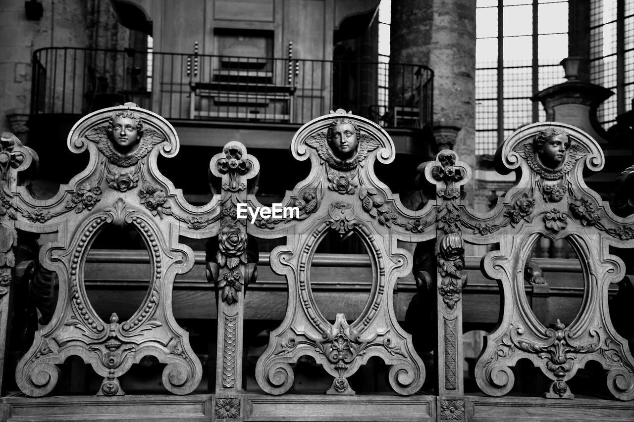 CLOSE-UP OF SCULPTURE AGAINST BUILDINGS