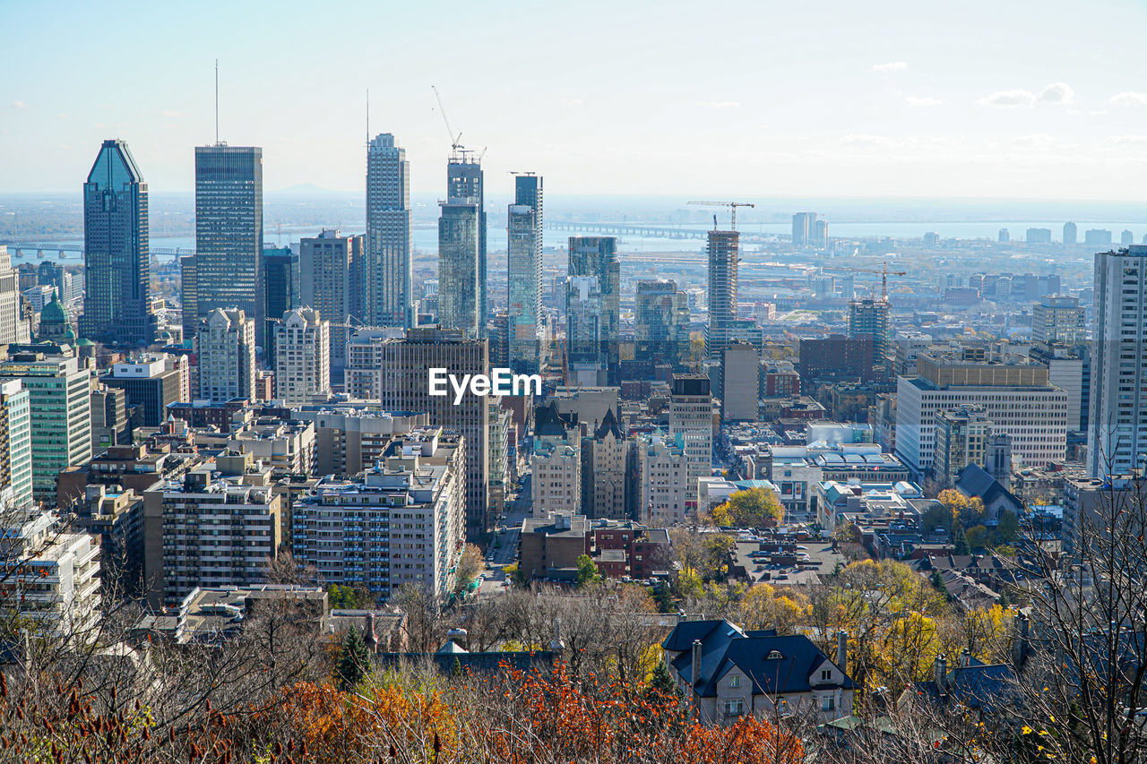 Aerial view of modern buildings in city against sky