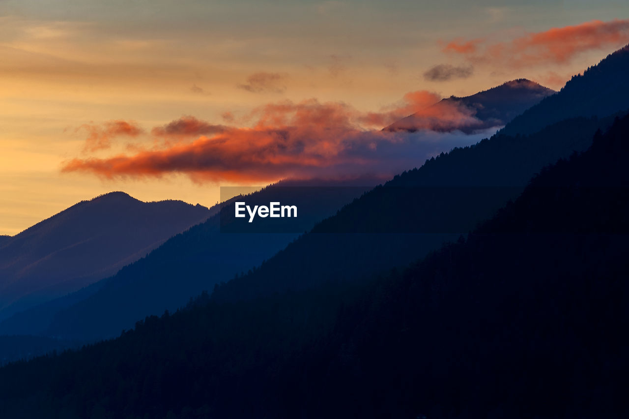 Scenic view of silhouette mountains against sky during sunset