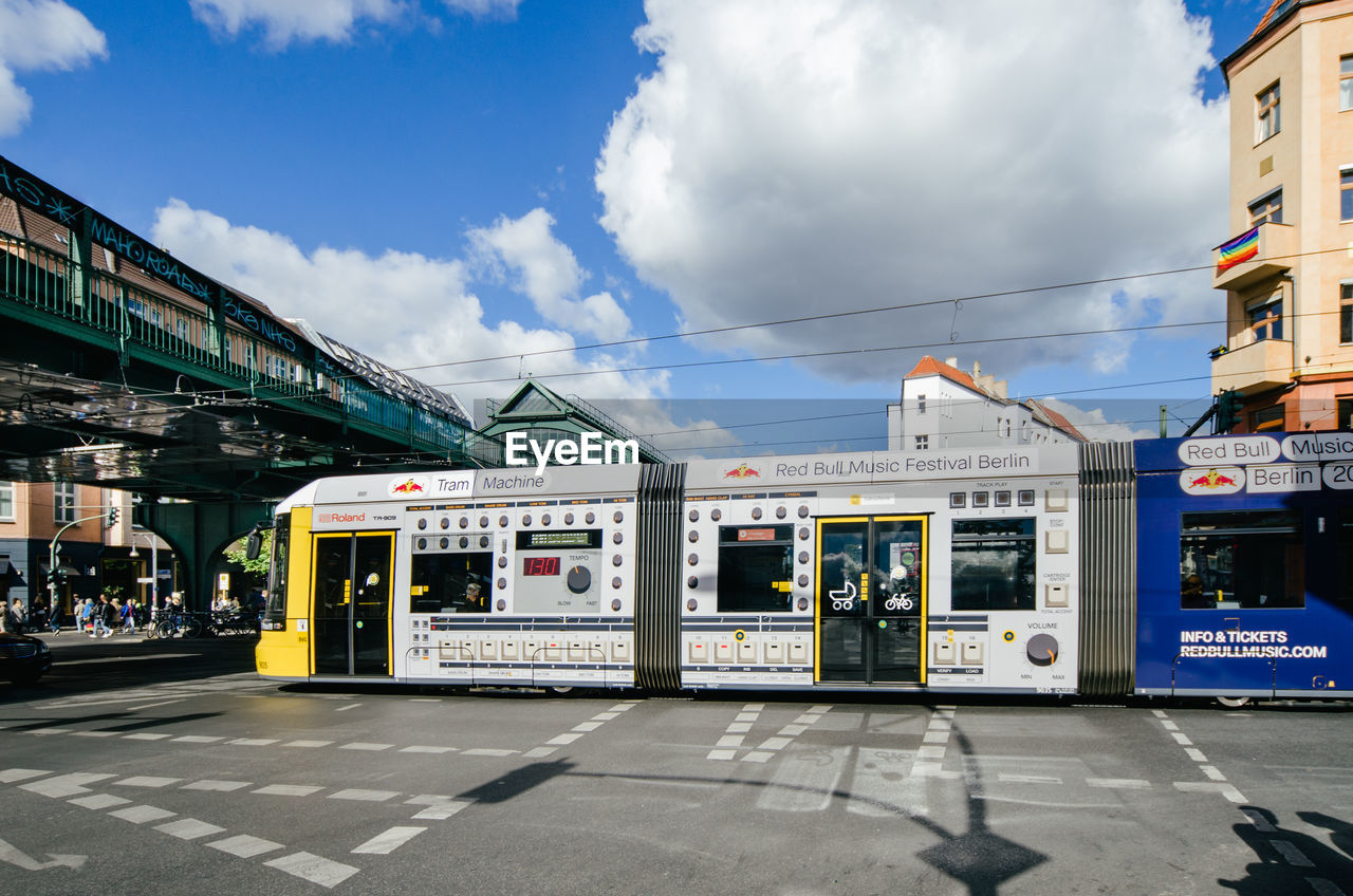 TRAIN AT RAILROAD STATION PLATFORM AGAINST SKY