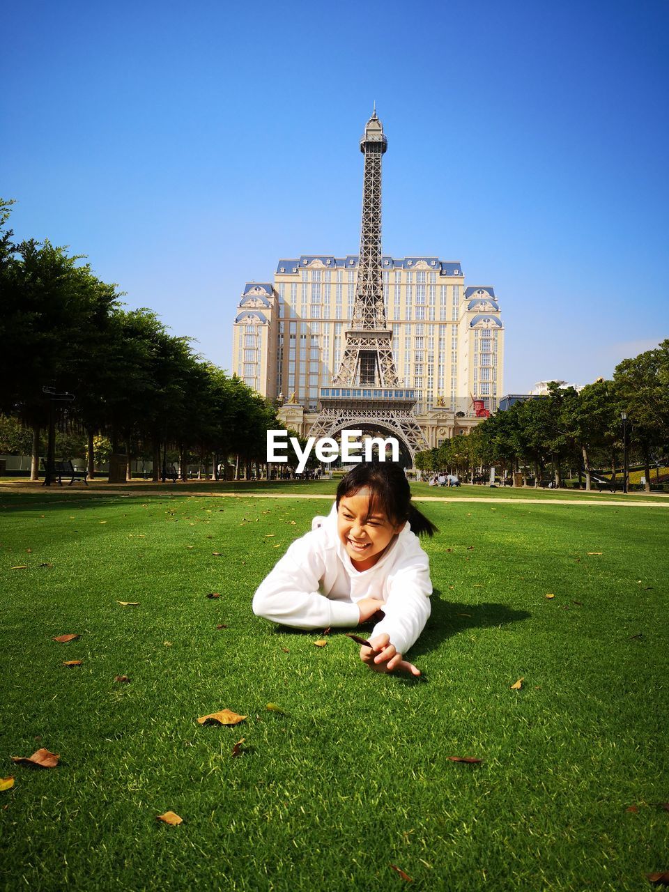 Smiling girl lying on grass