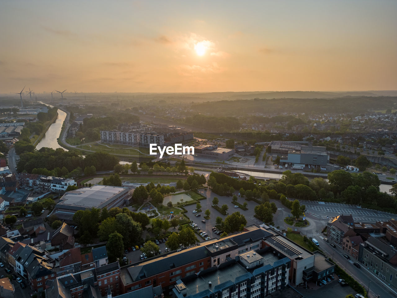 high angle view of buildings in city against sky during sunset