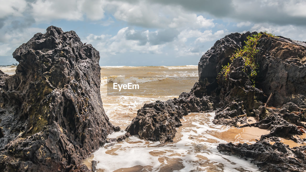  axim ghana. beaches with beautiful rocks formed by the waters of the west african sea