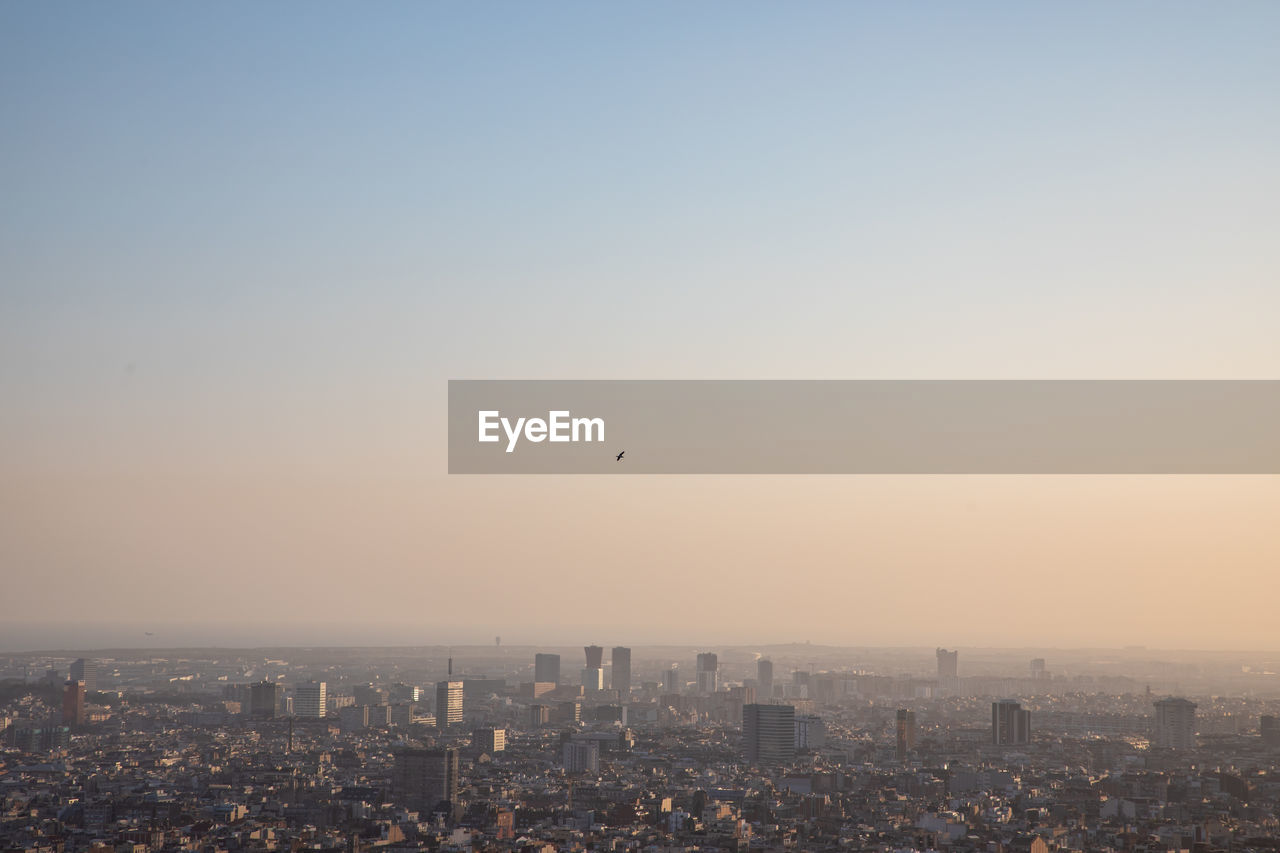 CITYSCAPE AGAINST SKY DURING SUNSET