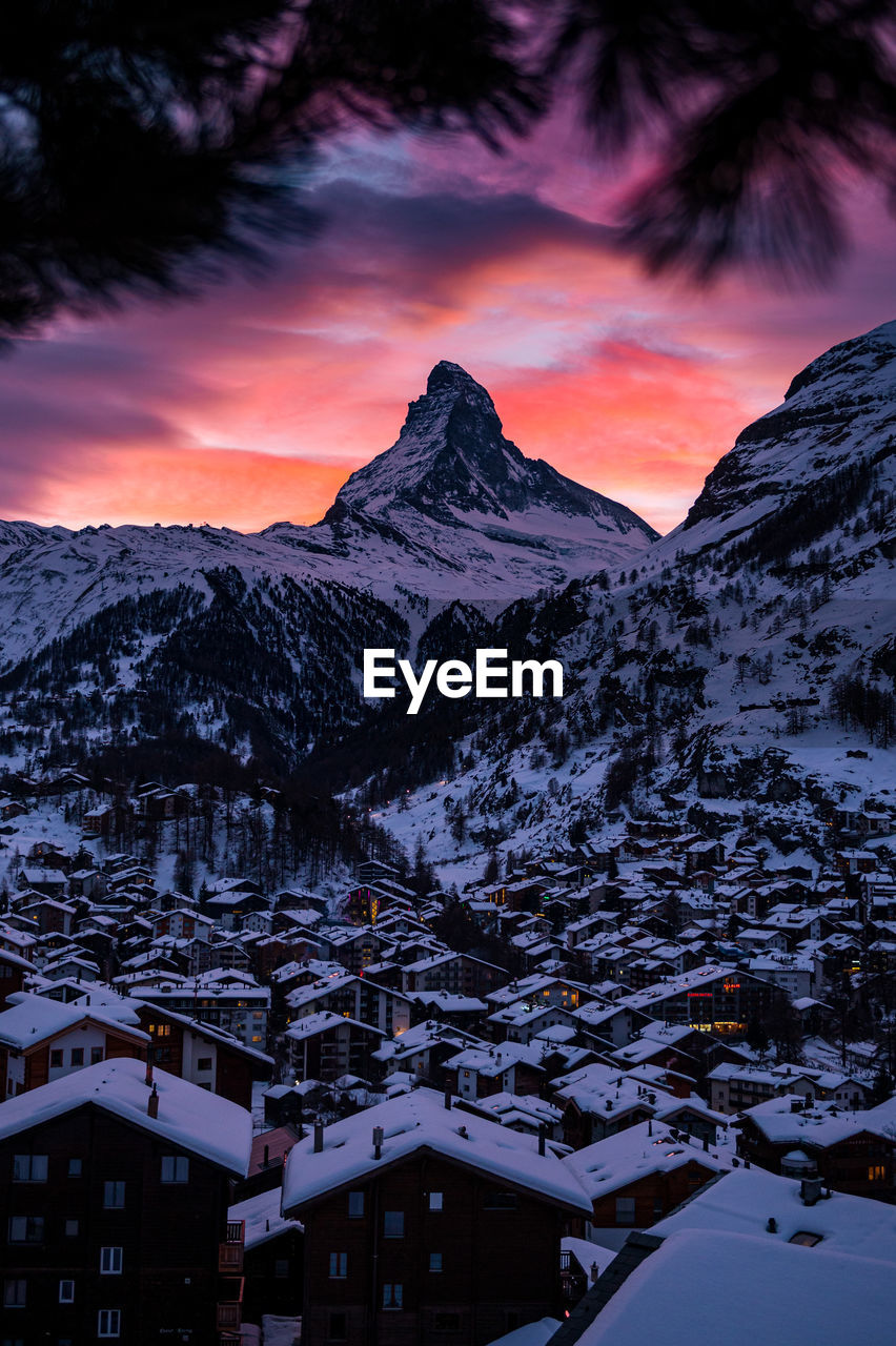 SNOW COVERED MOUNTAINS AGAINST SKY DURING SUNSET