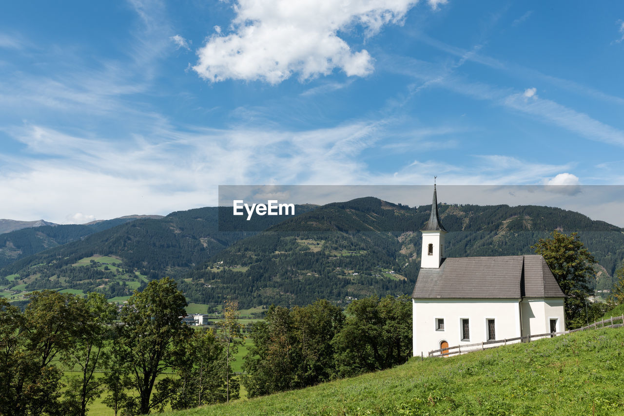 Church and mountains against sky