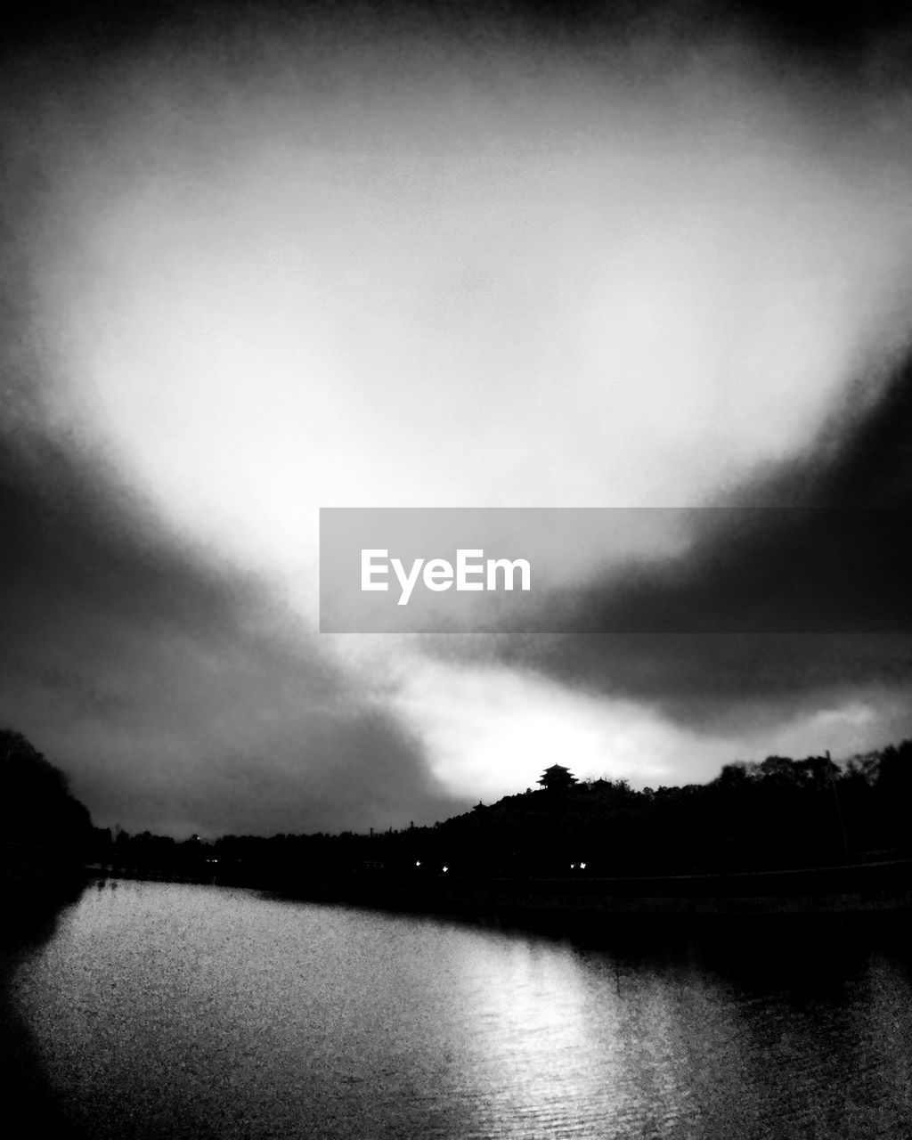 VIEW OF LAKE AGAINST CLOUDY SKY