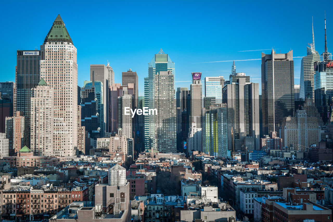 Modern buildings in city against clear sky