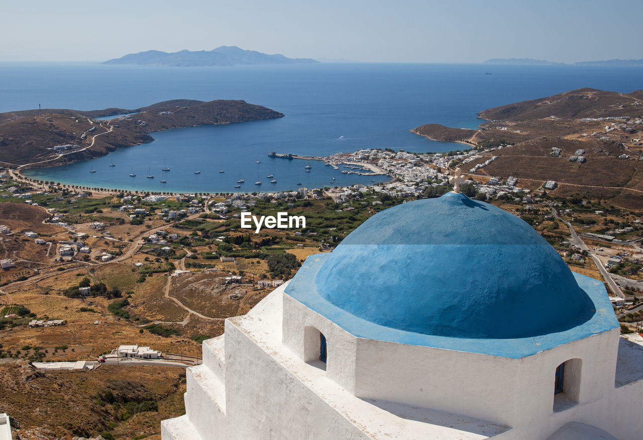 The port and beach town of livadi is viewed from the chora of serifos