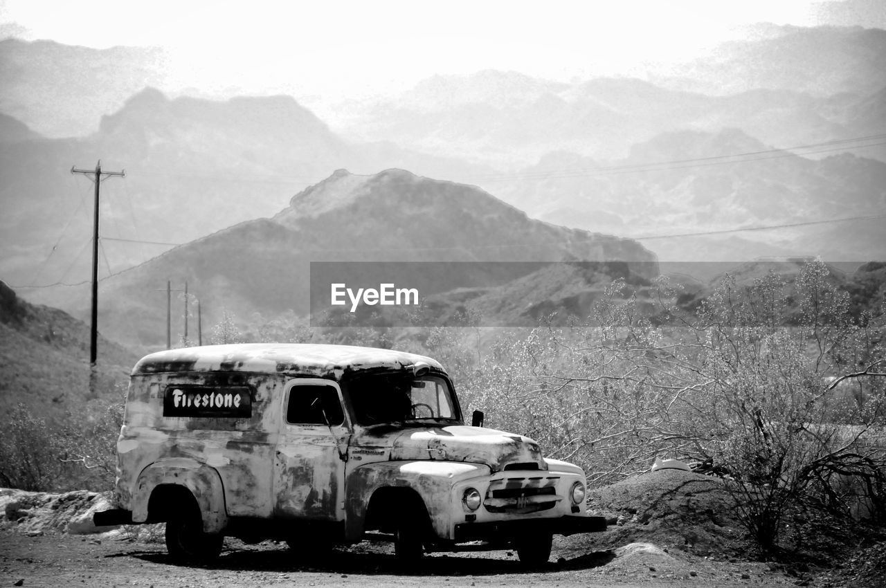 ABANDONED CAR ON LANDSCAPE