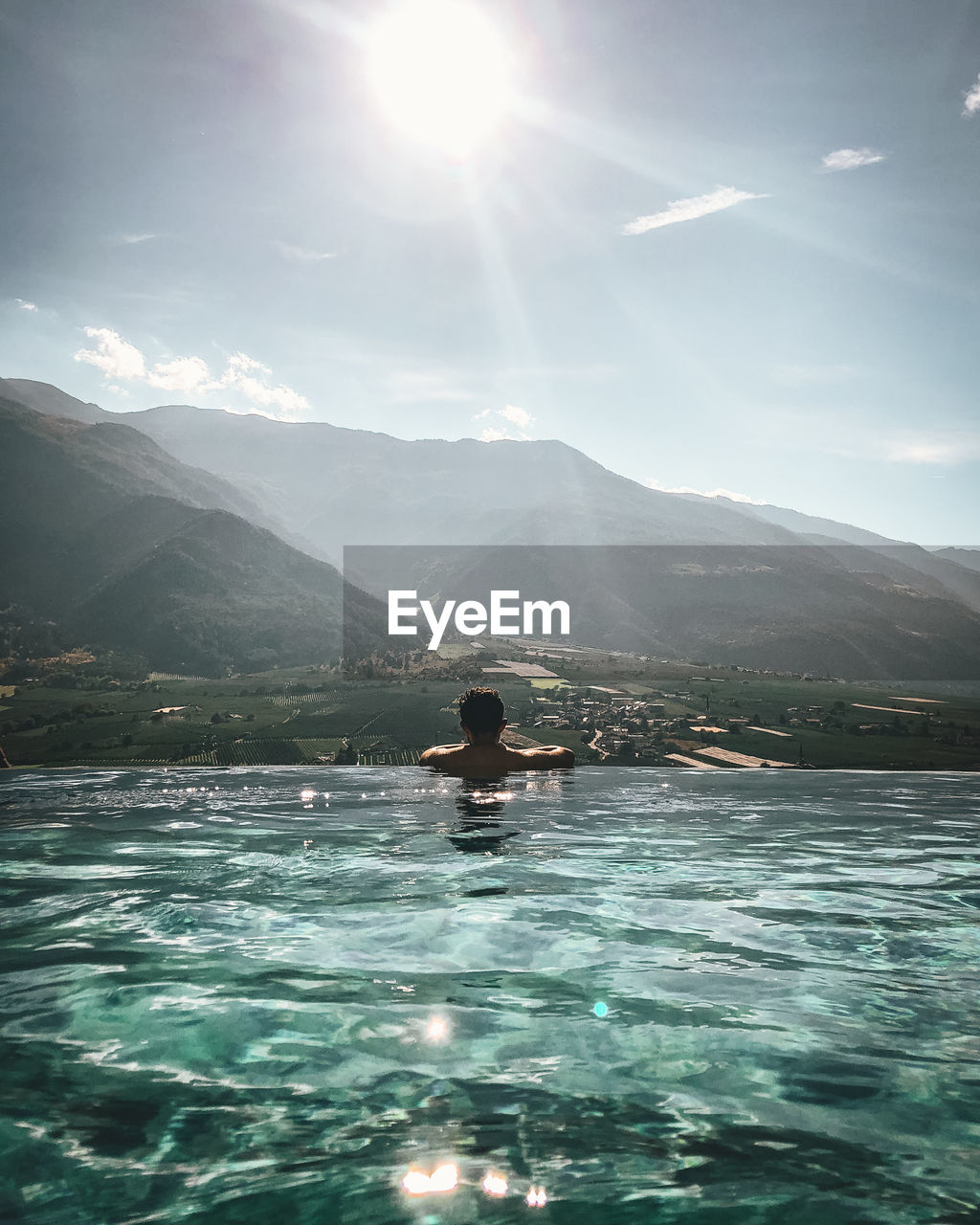 MAN ON SWIMMING POOL AGAINST SKY