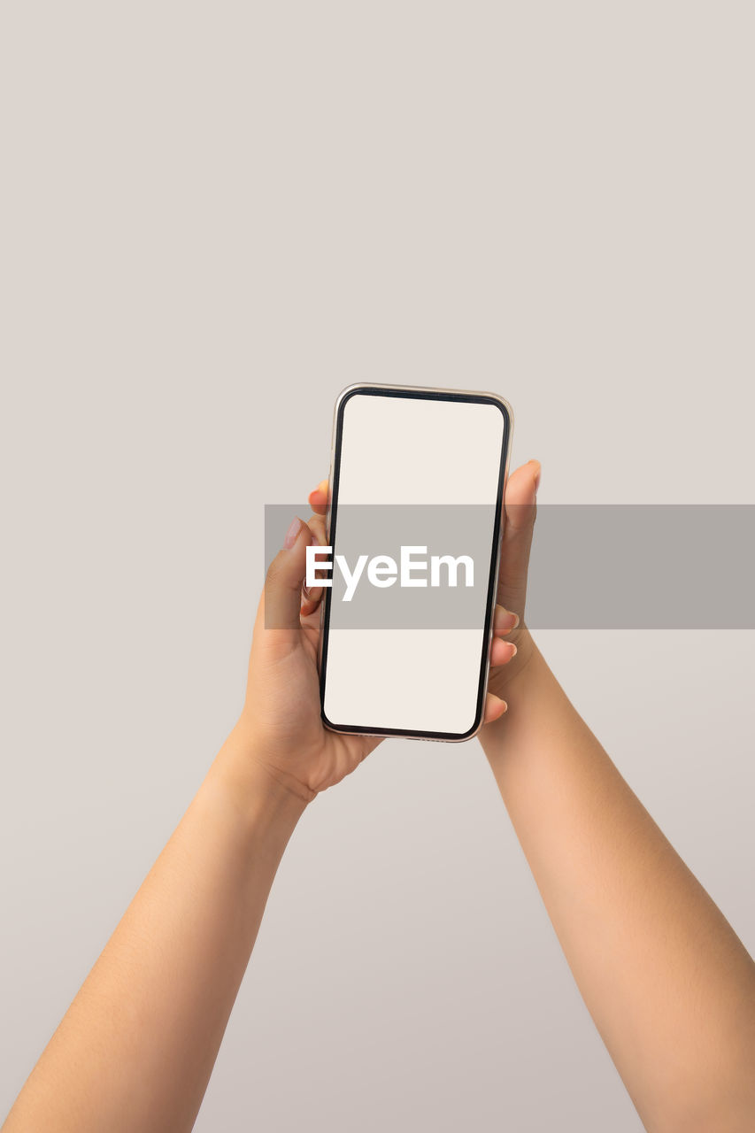 LOW SECTION OF PERSON HOLDING MOBILE PHONE
