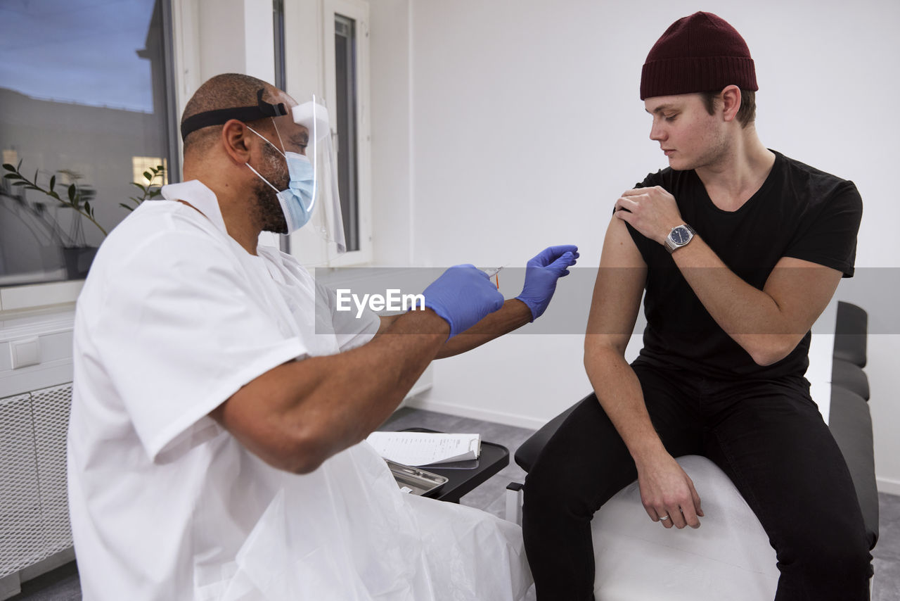 Young man getting vaccinated against covid-19