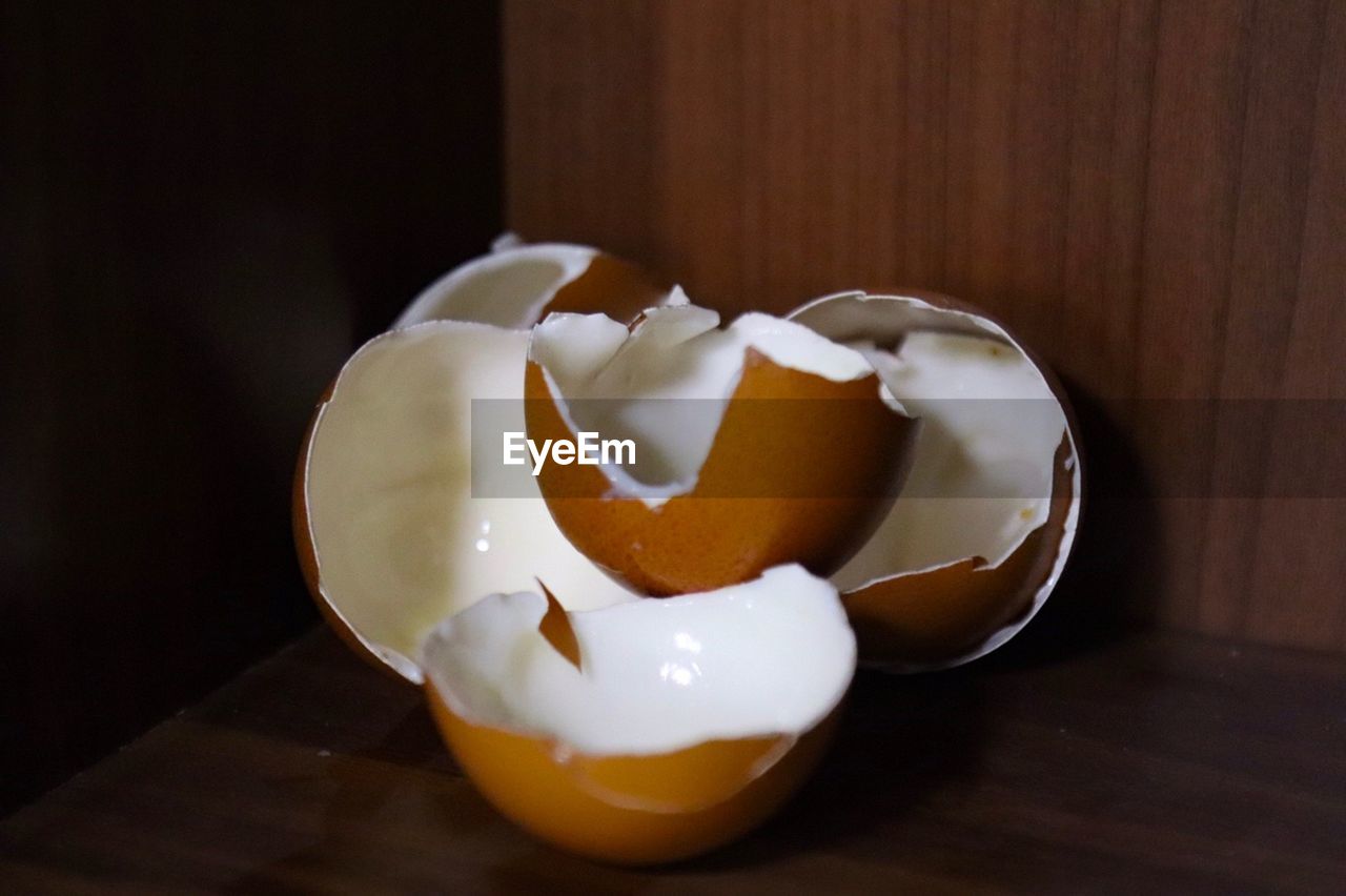 Close-up of broken egg on table