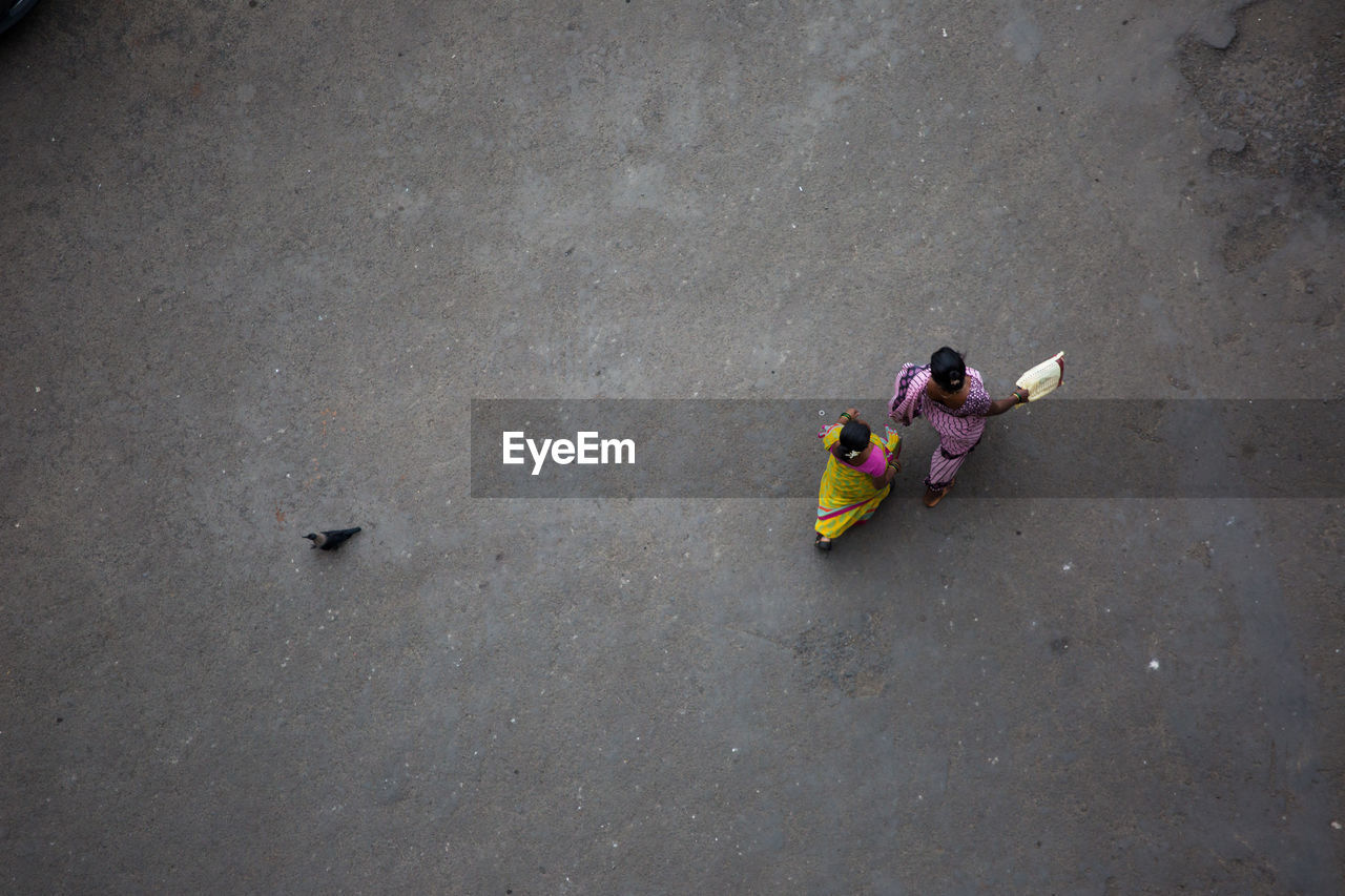 High angle view of women in sari walking on road