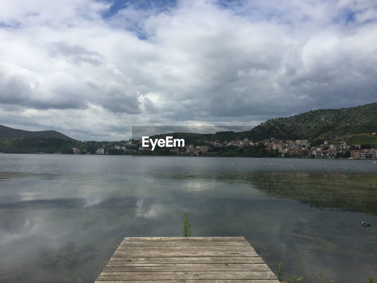 Pier over lake against sky